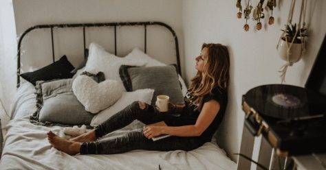 Woman drinking coffee on bed